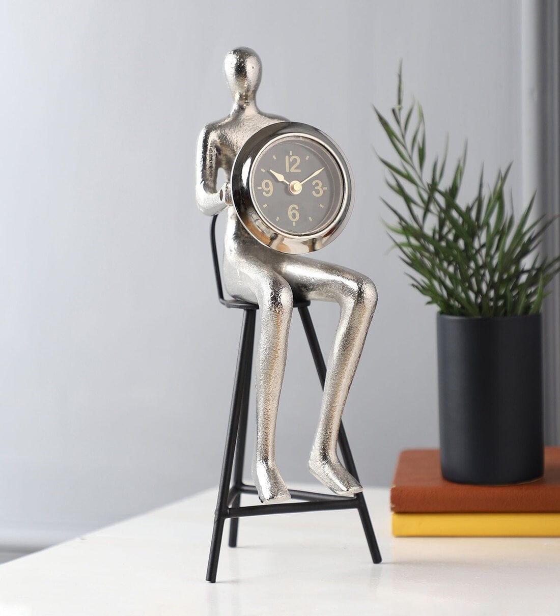 Sitting Man Clock In Silver,